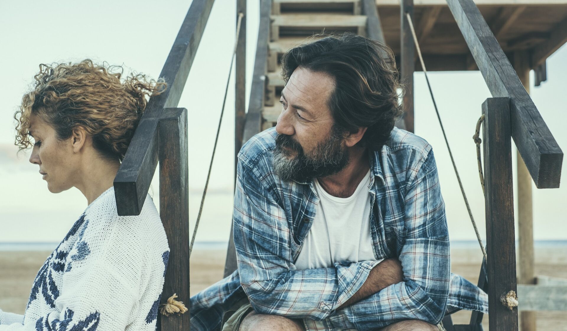 Couple problems and divorce concept with serious and sad man and woman outdoors separated